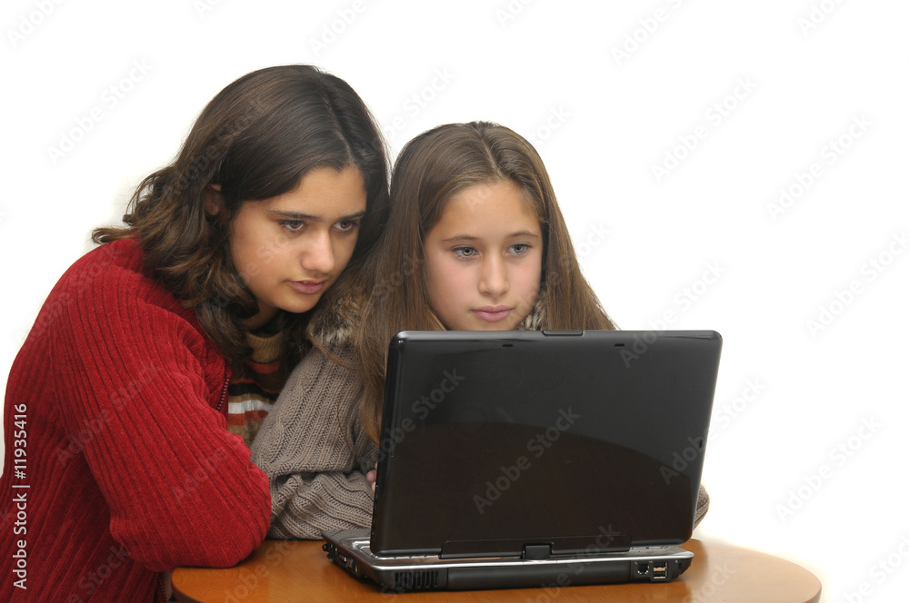Young girls with laptop isolated against a white background Young girls with laptop isolated against a white background