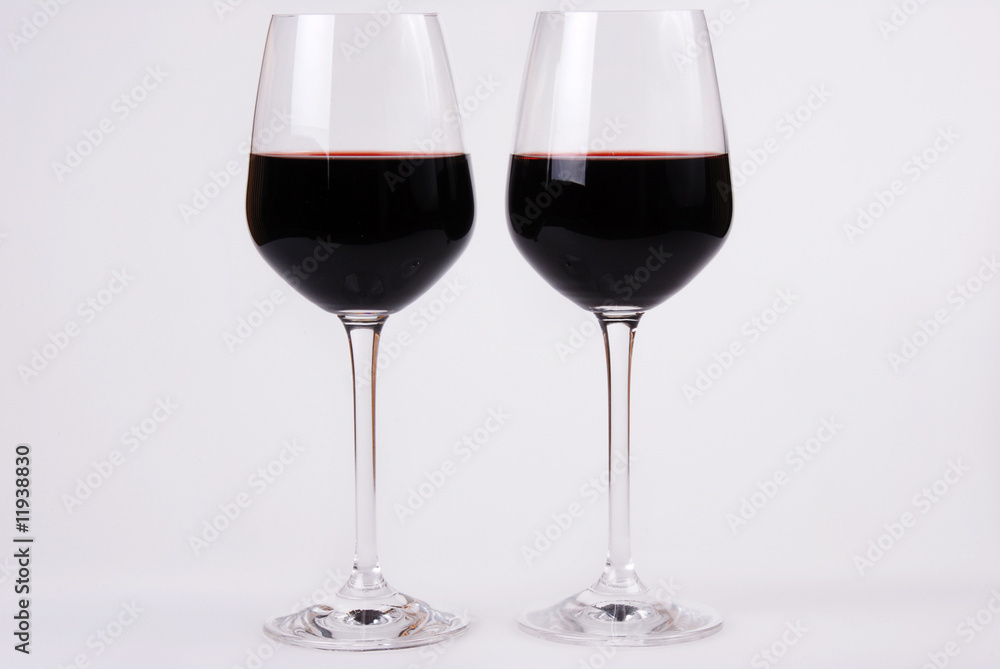 Two glass side by side with red wine. White background . Copy space.
