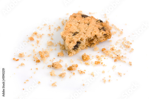 Last bite of a chocolate chip cookie with crumbs