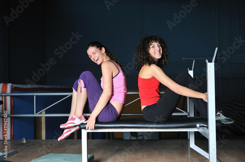 two women work out in fitness club