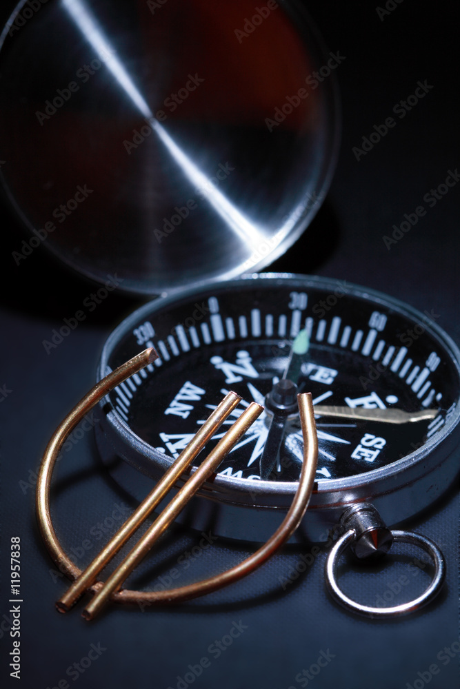 Fototapeta premium Euro sign made from wire lying on background with compass