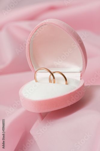 Wedding rings on background of the pink silk. © Andrey Stratilatov