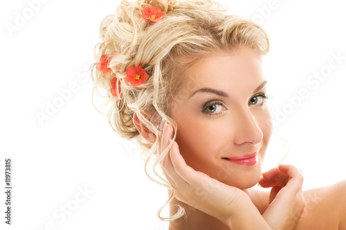 Beautiful young woman with fresh flowers in her hair