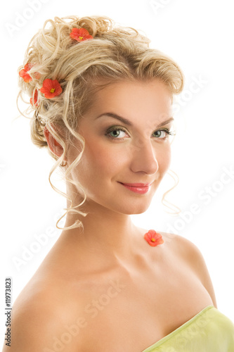 Beautiful young woman with fresh spring flowers in her hair.