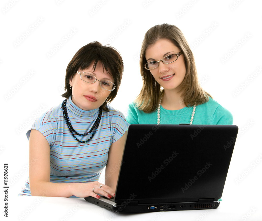 Two young women working on a laptop. Two young women working on a laptop.