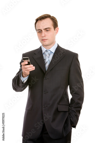 Young businessman with a mobile phone. Isolated on white.