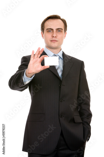 Young businessman showing a businesscard. Isolated on white.