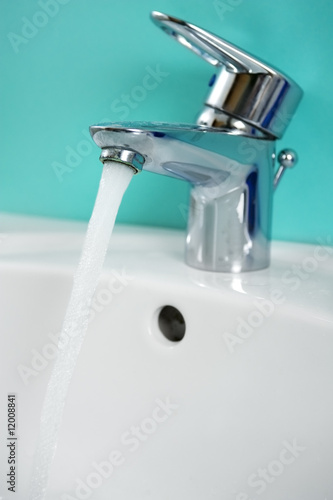 water tap with focus on water coming out of tap