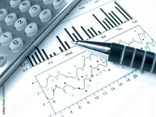 Pen and calculator against the graph (in blue)