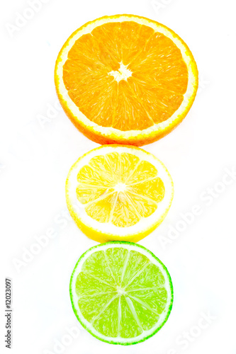 A traffic light formation of citrus fruits on white