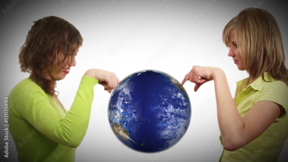 Businesswomen looking at a globe Businesswomen looking at a globe