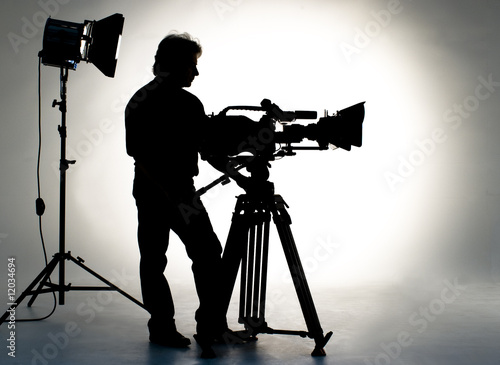 Searchlight and silhouette of the camera and cameraman.