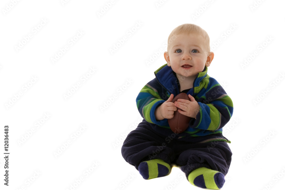 Happy baby boy holds football while smiling Happy baby boy holds football while smiling