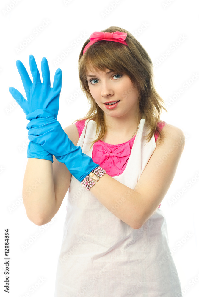 young housewife putting on rubber gloves young housewife putting on rubber gloves