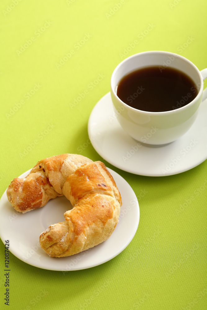 Breakfast concept with coffee and croissant
