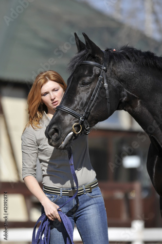 Young woman petting a horse
