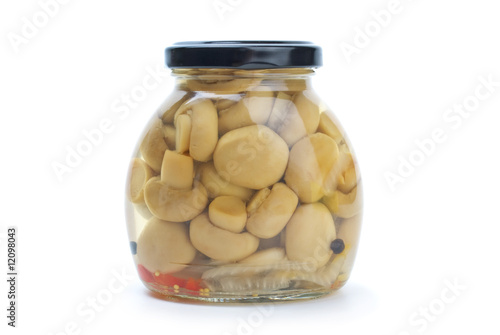 Glass jar with marinated champignons