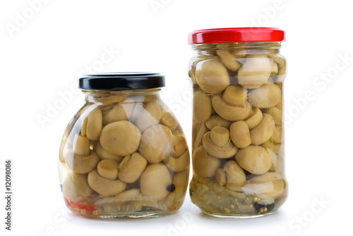 Two glass jars with marinated champignons