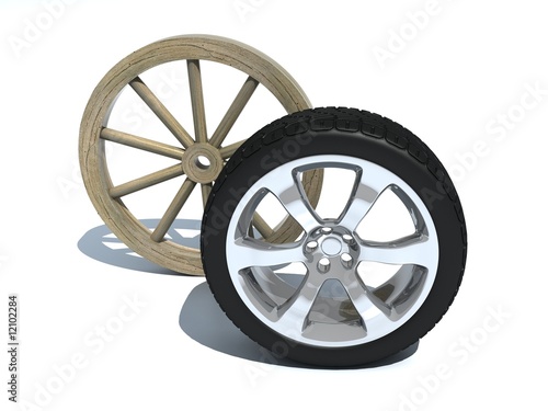 Old wooden wheel from a cart near to a modern automobile wheel