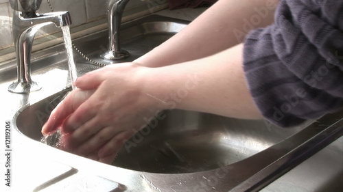 Footage of a woman eashing her hands at home