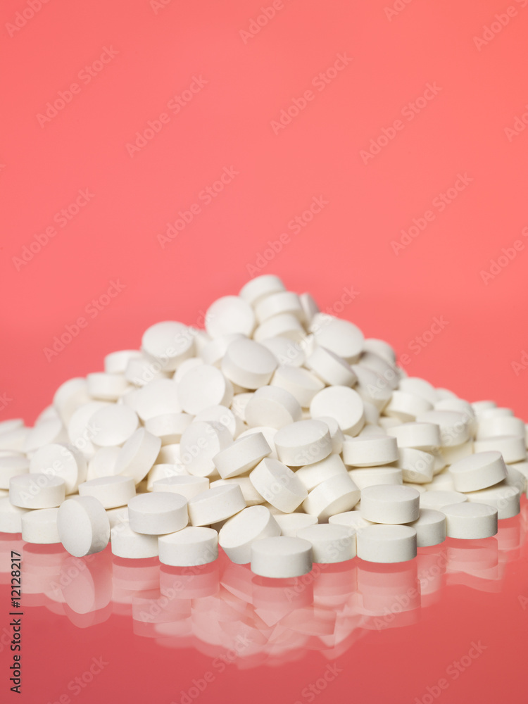 Stack of pills towards red background Stack of pills towards red background