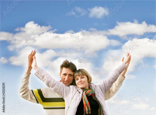 young happy couple over sky background