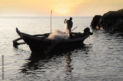 Fisherman with nets on his boat