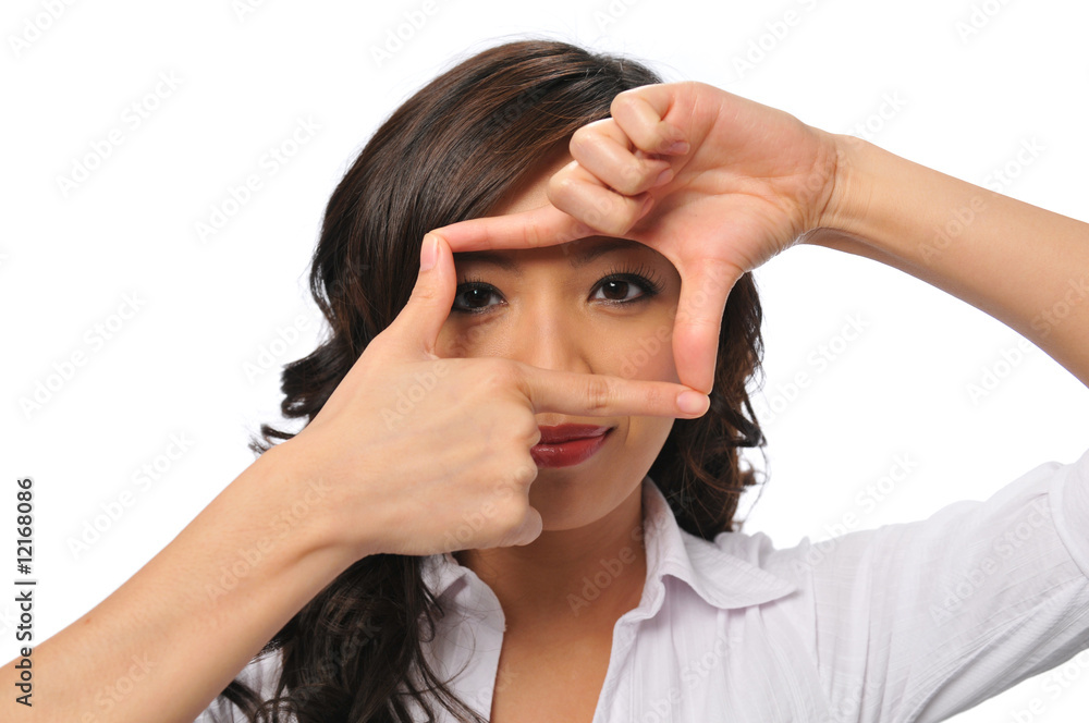 A pretty young asian woman with framing hands A pretty young asian woman with framing hands