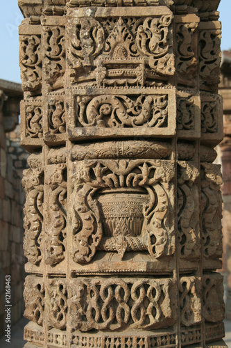 Carving of intricate design in stone pillar