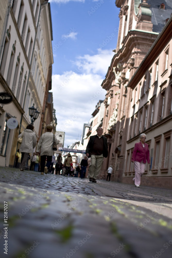 People walking through an old street