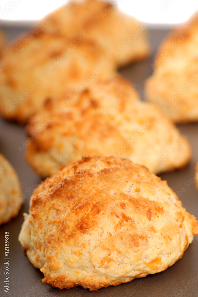 Cheddar cheese biscuits on a cookie sheet