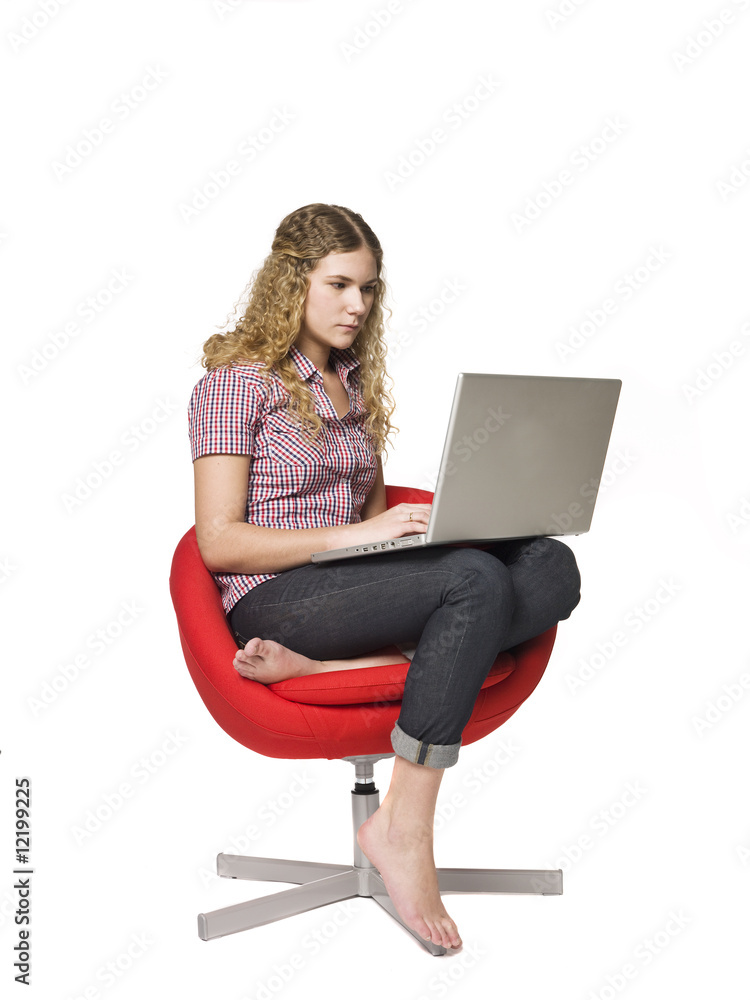 Girl in a armchair with a computer Girl in a armchair with a computer
