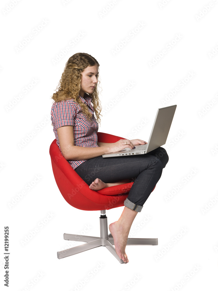 Girl in a armchair with a computer Girl in a armchair with a computer