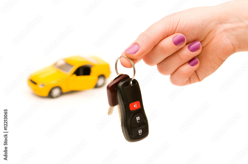 Car keys and car at background isolated on white