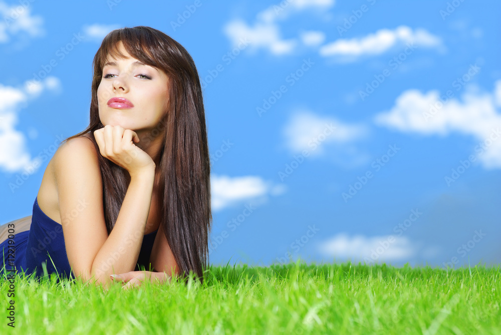 Smiling beautiful woman relaxing on the grass Smiling beautiful woman relaxing on the grass