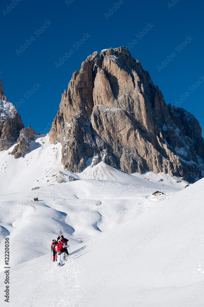 Italian Dolomites covered by snow and people with snowshoe
