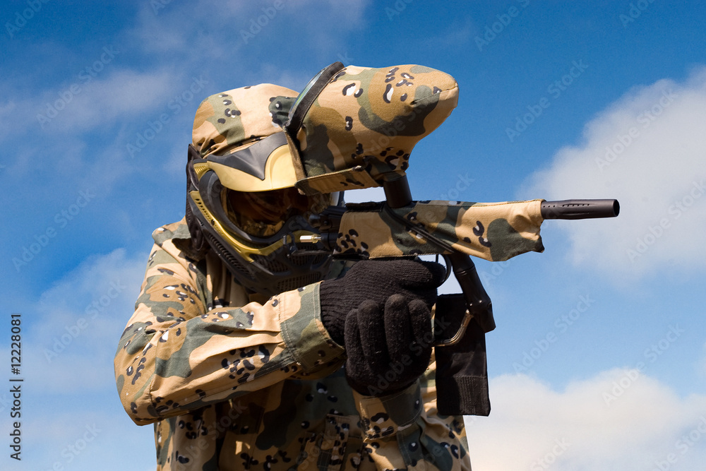Fototapeta premium Paintball player with gun