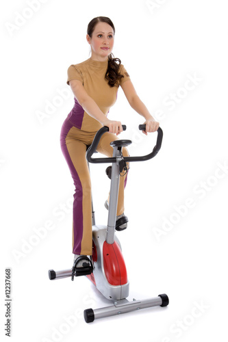 Attractive woman doing fitness on a stationary bike