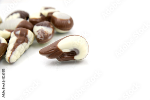 chocolate sweetmeats in form seashell on white background