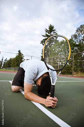 Sad tennis player after defeat