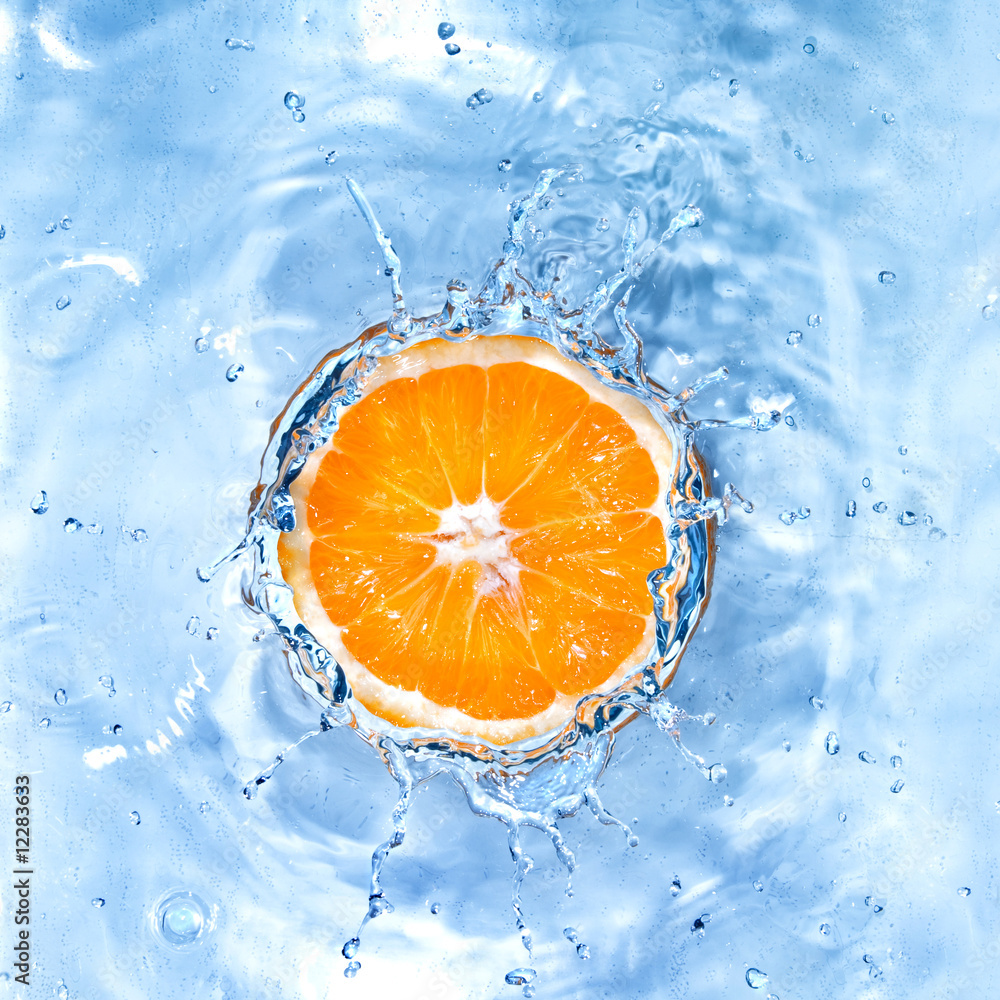 Fresh orange dropped into water with bubbles isolated on white Fresh orange dropped into water with bubbles isolated on white