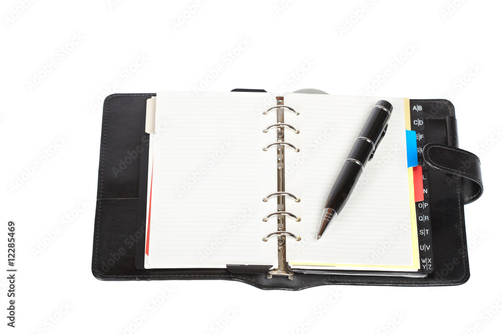 Opened agenda with pen Opened agenda with pen