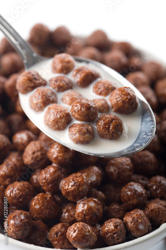 spoon full of chocolate balls and milk isolated