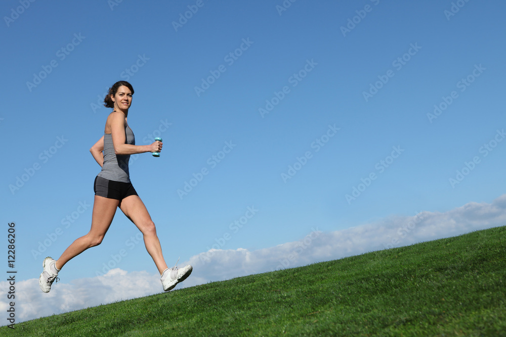 fit healthy woman exercising running uphill fit healthy woman exercising running uphill