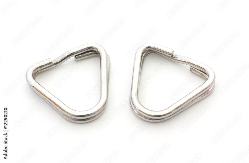 Two metal camera strap eyelets in a triangular shape. Two metal camera strap eyelets in a triangular shape.