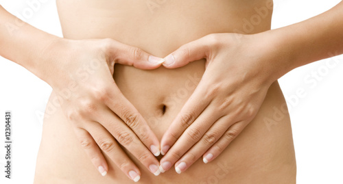 Love - A woman's hands forming a heart symbol on belly photo