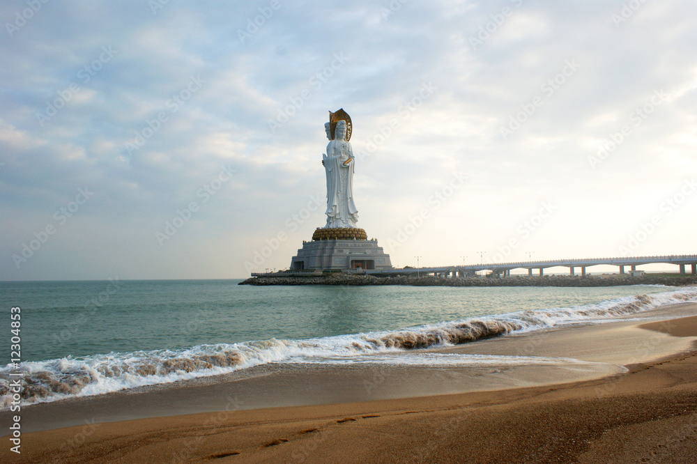 Statue of Guanyin, Chinese goddess, far view from seashore
