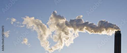 фотографія Smoking chimney against a blue sky