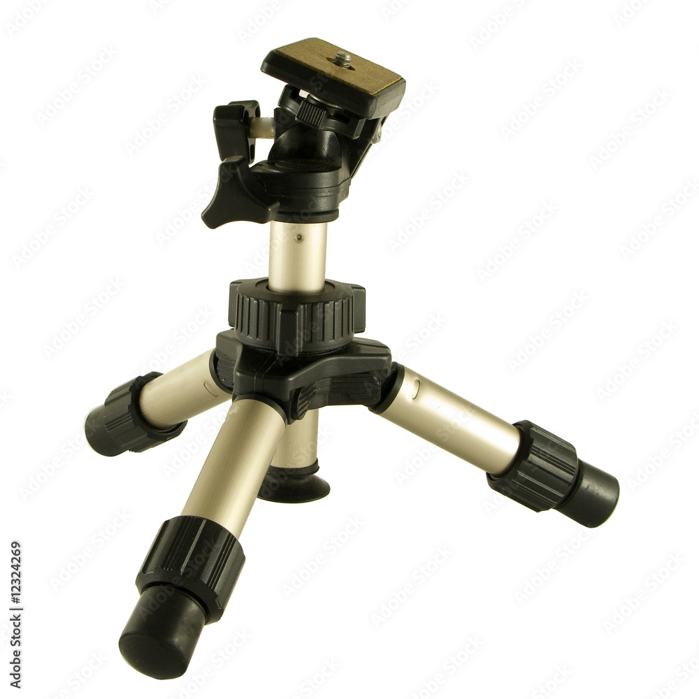 A photographers mini tripod isolated over a white background A photographers mini tripod isolated over a white background