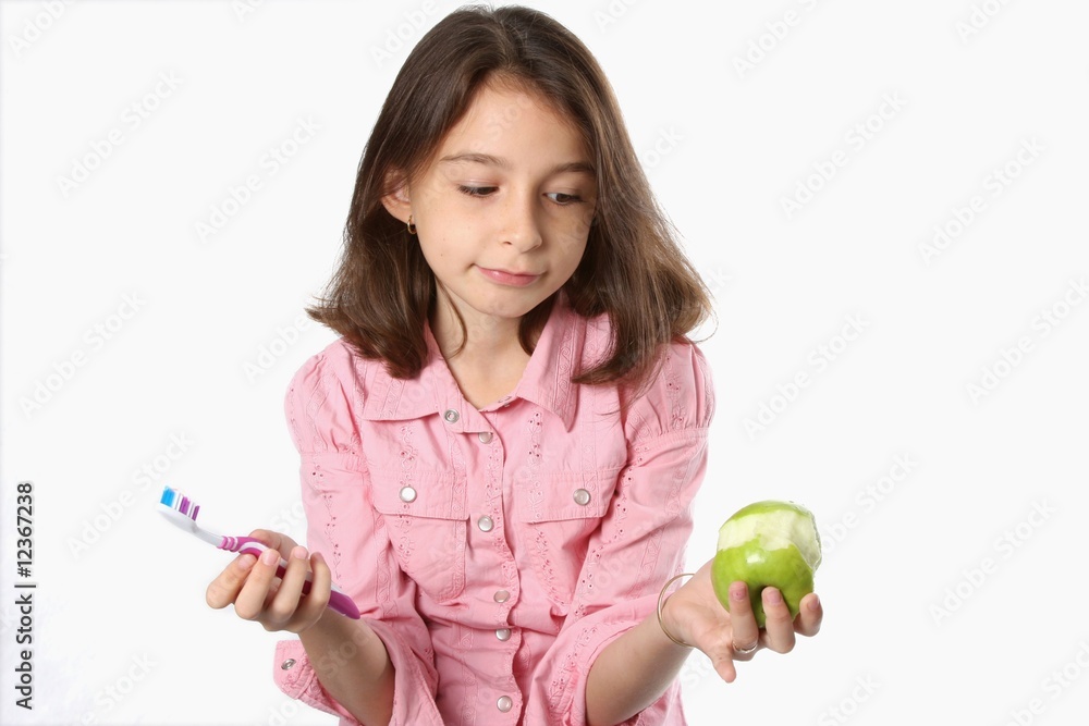 Fototapeta premium Young Girl With Toothbrush And Apple